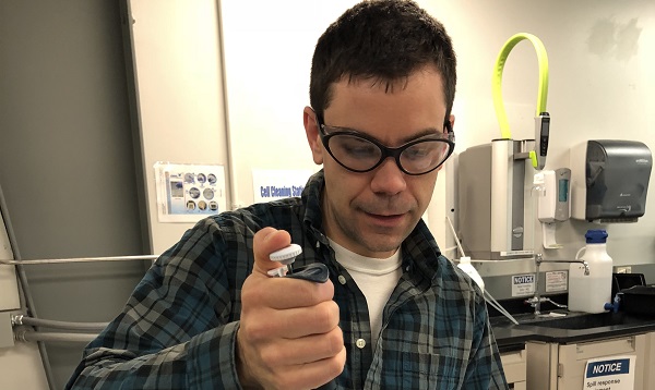 Cory Knoot prepares a sample of blue-green algae